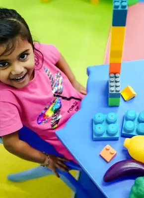Child participating in engaging learning activities that support creativity and confidence